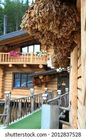 Oak Brooms For Russian Banya Hangs On A Wood Wall
