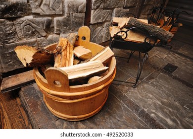 Oak Firewood In Wooden Barrel On The Background Of Fire