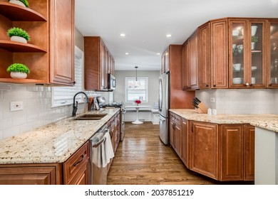 OAK PARK, IL, USA - APRIL 4, 2020: A Kitchen With Dark Wood Cabinets, Granite Countertops, Hardwood Floors, And A Breakfast Nook.