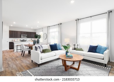 OAK PARK, IL, USA - AUGUST 15, 2021: A Renovated Living Room, Dining Room, And Kitchen With Dark Wood Cabinets And Hardwood Floors.