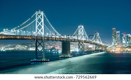 Oakland Bay Bridge and the city light at night.