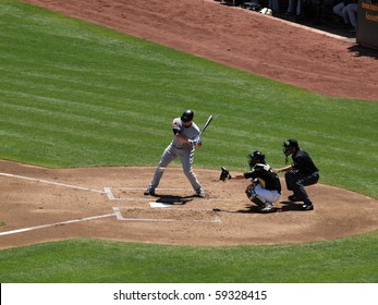 OAKLAND, CA - AUGUST 18: Blue Jays Vs. Athletics: Lyle Overbay Looks At Incoming Pitch As It Crosses Plate With Kurt Suzuki Catching On August 18, 2010 At Coliseum In Oakland California.