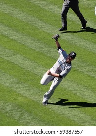 OAKLAND, CA - AUGUST 18: Blue Jays Vs. Athletics: Blue Jays Lyle Overbay Stands Off Balance After Making A Running Catch For A Fly Ball.  Taken On August 18 2010 At Coliseum In Oakland California.