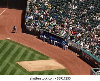OAKLAND, CA - AUGUST 4: Royals vs. Athletics: Kansas City Royals pitchers sit the the bullpen with fans sitting behind them. .  Taken on August 4 2010 at Coliseum in Oakland California.