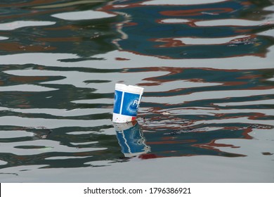 Oakland, CA - Dec 13, 2016:  styrofoam cup floating in water. Take-out food and beverage containers, such as Styrofoam cups, are some of the most ubiquitous trash items fouling local waterways.