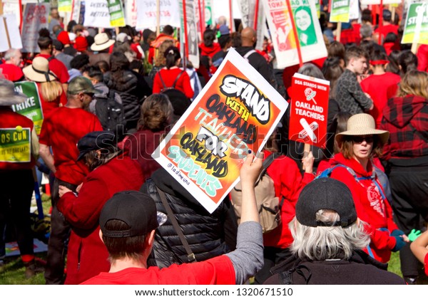 Oakland, CA - February 22, 2019: Unidentified\
participants at Oakland teachers strike day 2 rally at DeFremery\
Park, then marching downtown. Fighting for smaller class sizes and\
bigger paychecks.