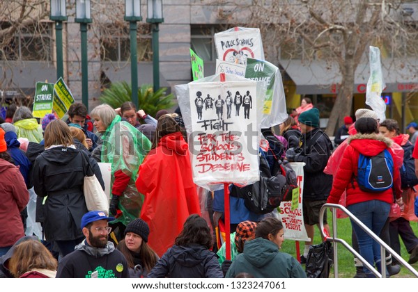 Oakland, CA -\
February 25, 2019: Unidentified participants at Oakland teachers\
strike day 3 rallying at Frank Ogawa Plaza. Fighting for smaller\
class sizes and bigger\
paychecks.