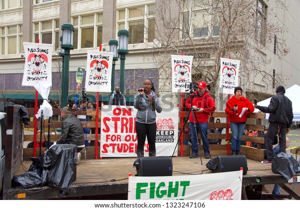 Oakland, CA -\
February 25, 2019: Unidentified participants at Oakland teachers\
strike day 3 rallying at Frank Ogawa Plaza. Fighting for smaller\
class sizes and bigger\
paychecks.