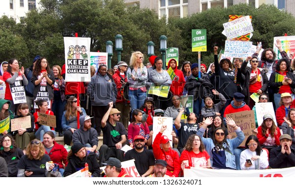 Oakland, CA - February 28, 2019: Unidentified\
participants at Oakland teachers strike day 6 rallying at Frank\
Ogawa Plaza downtown. Fighting for smaller class sizes and bigger\
paychecks.