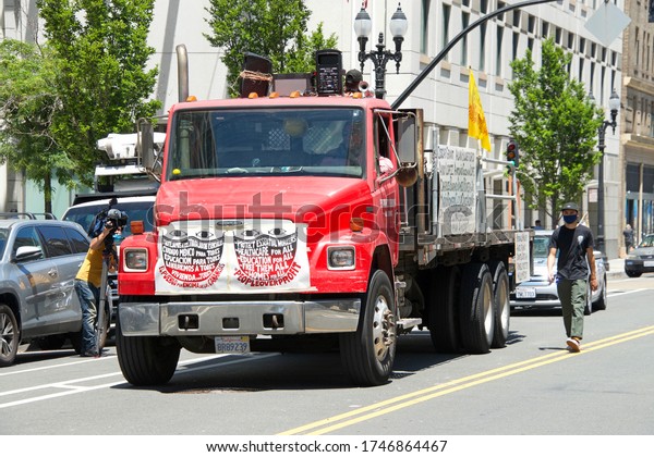 Oakland, CA - June 01, 2020: Lead truck in the\
auto caravan for the People\'s Strike Coalition, protesting lack of\
PPE during the Covid-19 pandemic in addition to protesting the\
death of George Floyd.