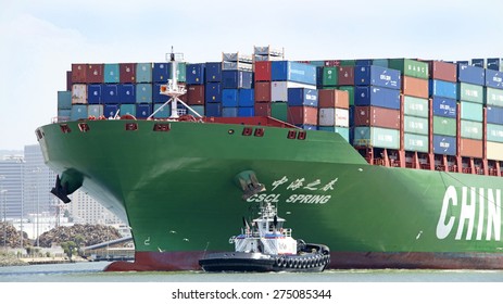 OAKLAND, CA - MAY 03, 2015: China Shipping Lines Cargo Ship CSCL SPRING entering the Port of Oakland  with tugboat PATRICIA ANN assisting from the Port Bow.