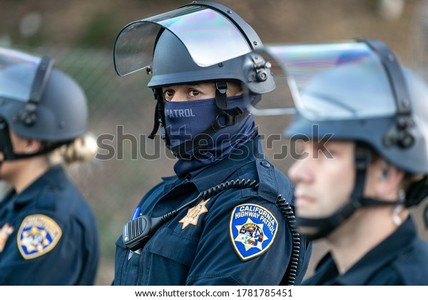Oakland, California - 6/10/20:\
California Highway Patrol officers guard the entrance to Interstate\
580 freeway from demonstrators from the George Floyd\
protest.