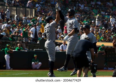 Oakland, California - August 28, 2021: Aaron Judge #99 And Giancarlo Stanton #27 Of The New York Yankees Celebrate After Judge Hits A Home Run Against The Oakland Athletics At RingCentral Coliseum.