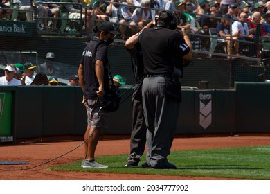 Oakland, California - August 28, 2021: Home Plate Umpire Tony Randazzo #11 Wears A Headset For Review During A Game Between The New York Yankees And Oakland Athletics At RingCentral Coliseum.