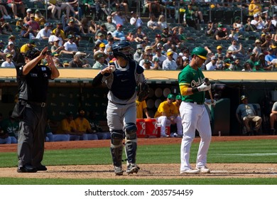 Oakland, California - August 28, 2021: Oakland Athletics' Yan Gomes #23 Reacts After New York Yankees Catcher Gary Sanchez #24 Catches A Found Tip Third Strike Indicated By Umpire Tony Randazzo #11.