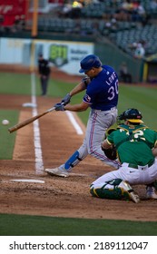 Oakland, California - July 23, 2022: Texas Rangers First Baseball Nathaniel Lowe Hits Against The Oakland Athletics At The Oakland Coliseum.