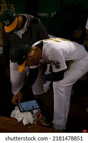 Oakland, California - July 5, 2022: Oakland Athletics Chad Pinder And Tony Kemp Watch Highlights On An Tablet After The A's Win Over The Toronto Blue Jays At The Oakland Coliseum.