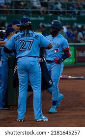 Oakland, California - July 5, 2022: Toronto Blue Jays Infielder Vladimir Guerrero Jr. Prepares To Put The Home Run Jacket On Teoscar Hernández During A Game At The Oakland Coliseum.