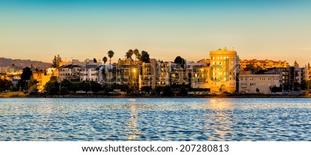 Oakland, California Lake Merritt waterfront buildings at sunset