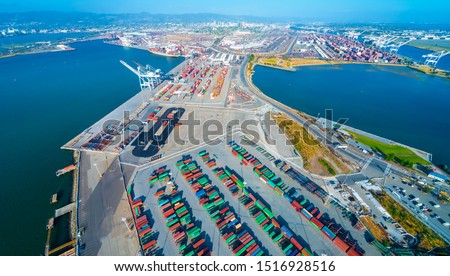 Oakland Harbor port terminal with shipping containers and cranes