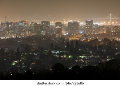 Oakland And San Francisco Cityscapes On A Hazy Summer Night. Oakland Hills, Alameda County, California, USA.