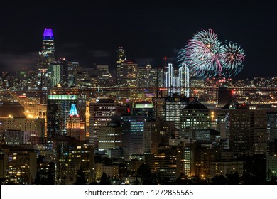 Oakland And San Francisco Downtowns With New Year's Eve 2019 Fireworks. Oakland Hills, Alameda County, California, USA.