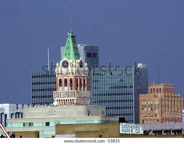 Oakland Tribune Tower, downtown Oakland, CA set\
against a modern office\
building