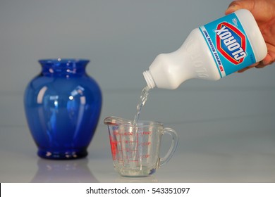 OAKLAND, USA - JUL 20, 2005: Hand Pouring Bleach On Measuring Cup