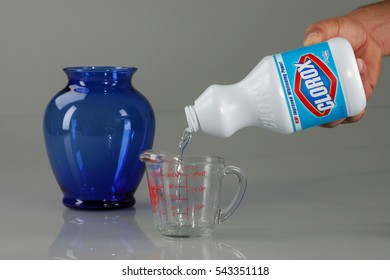 OAKLAND, USA - JUL 20, 2005: Hand Pouring Bleach On Measuring Cup