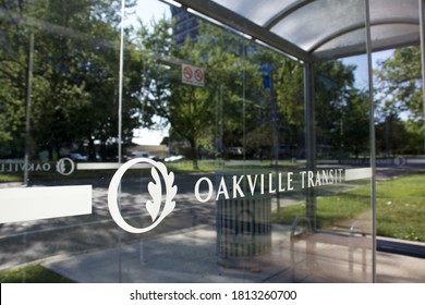 Oakville, Ontario / Canada - September 11, 2020: Oakville Transit Logo On The Transparent Glass Of A Shelter At The Bus Stop In A Green Residential Neighbourhood.