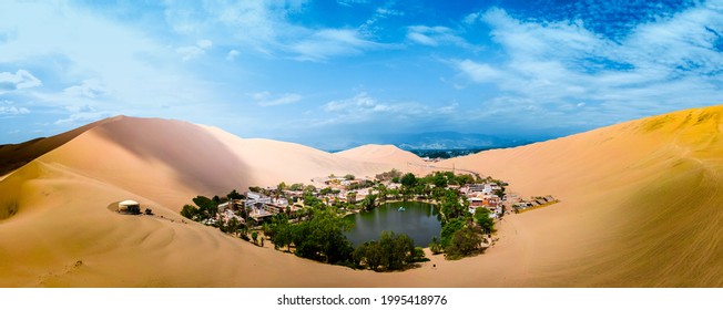 Oasis of Huacachina near Ica city in Peru. Lake and trees inside the dunes