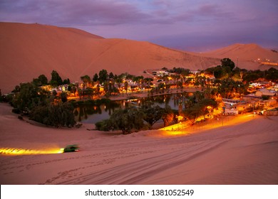 Oasis Of  Huacachina At Night With Dune Buggy Blurred Motion, Ica Region, Peru.