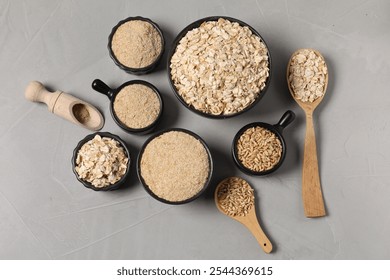 Oat bran, flakes and grains on grey table, flat lay - Powered by Shutterstock