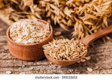 Oat ears of grain on a wooden table, oatmeal. Bounteous harvest. A  Healthy fresh Dry Oat meal  - Shutterstock ID 390533653