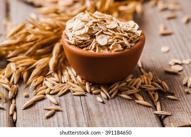 Oat ears of grain on a wooden table, oatmeal. Bounteous harvest. A  Healthy fresh Dry Oat meal  - Shutterstock ID 391184650