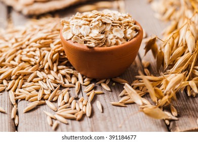 Oat ears of grain on a wooden table, oatmeal. Bounteous harvest. A  Healthy fresh Dry Oat meal  - Shutterstock ID 391184677