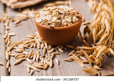 Oat ears of grain on a wooden table, oatmeal. Bounteous harvest. A  Healthy fresh Dry Oat meal  - Shutterstock ID 391184737