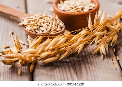 Oat ears of grain on a wooden table, oatmeal. Bounteous harvest. A  Healthy fresh Dry Oat meal  - Shutterstock ID 391416220