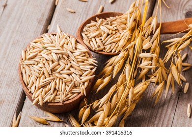 Oat ears of grain on a wooden table, oatmeal. Bounteous harvest. A  Healthy fresh Dry Oat meal  - Shutterstock ID 391416316