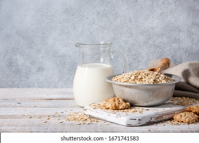 Oat flakes, milk and cookies on wooden table