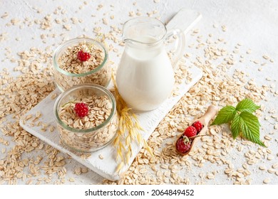 Oat Flakes, Out Milk And Rasberry On A Table. Plant-based Healthy And Vegetarian Eating And Drink. Selective Focus, Close Up