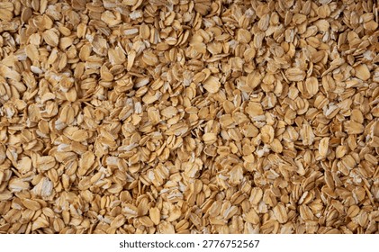 Oat flakes textured pattern, rolled oatmeal macro background. Dry cereal porridge flakes, quick flat spelt seeds ready for eating