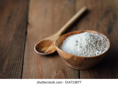Oat flour in old wooden bowl on dark wooden background - Shutterstock ID 514713877