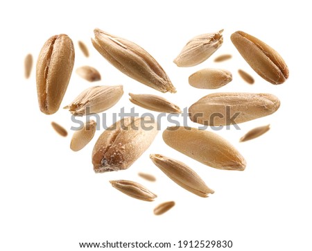 Oat grains in the shape of a heart on a white background