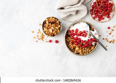 Oat granola with natural greek yogurt and red currant berries on grey cement wall. Top view with copy space. Clean eating, dieting concept - Powered by Shutterstock