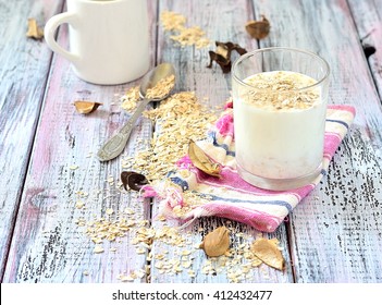 Oat Milk In A Glass On The Table With Dried Fruit