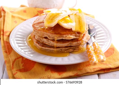 Oat  Pancakes With Banana And Honey On Plate