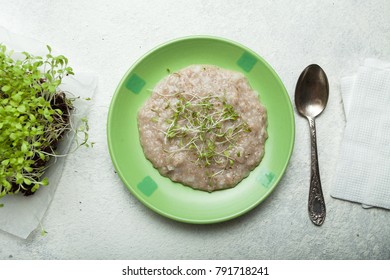 Oat Porridge With Micro-green On The Plate. A Healthy Nutritious Breakfast To Improve Brain Function. View From Above.