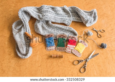 oat wool socks with darn materials like, mushroom, needle-case, needles, scissors and wool in several colors of former wool factory J.A.C., that no longer exists