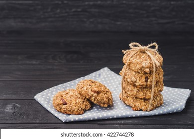 Oatmeal and banana cookies with raisins, tied with a twine, cinnamon sticks and star anise on napkin on black wooden table. Food, holiday, cooking, baking background. Concept of home, healthy eating. - Powered by Shutterstock